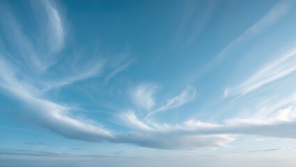 Blue daytime sky featuring white cirrus and stratus clouds