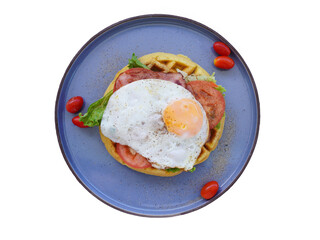 Fresh waffles with fried eggs, lettuce, tomatoes 