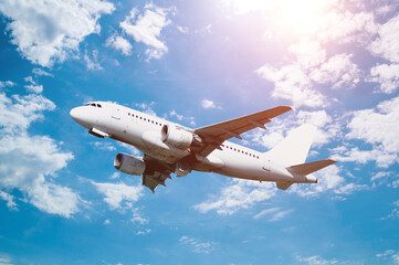 White airplane flying in the sky - travel background with airplane flight