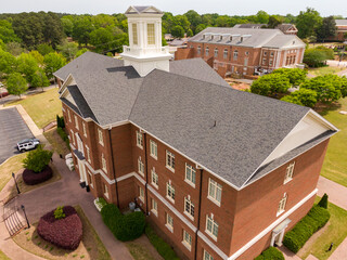 Sunny Daytime Drone Images of Large Commercial Roofs Featuring Asphalt Shingles, Metal Accents,...