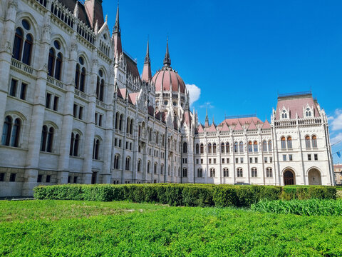 Hungarian Parliament Building on Kossuth Square in Spring, with green glass and beautiful garden in front, designed by Hungarian architect Imre Steindl in neo-Gothic style, Budapest, Hungary