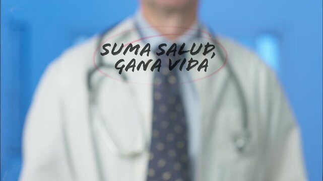 Male doctor writing and circling the spanish words suma salud, gana vida which means add health, win life on a transparent board with a red marker