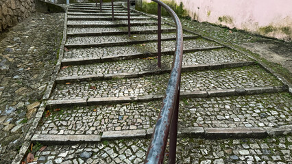 Cobblestone staircase with antique railing, rustic European charm, perfect for travel, history...