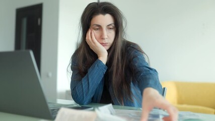 Anxious woman overwhelmed by financial problems and unpaid household bills