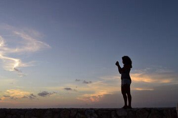 Woman Watching the Sunset on the Curaçao Seafront
