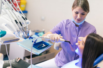 Portraits of doctor and patient in dentist's office. Shallow DOF. Developed from RAW; retouched...