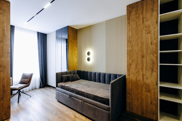 A comfortable bedroom featuring a bed, a chair, shelves, and a window