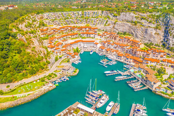 Aerial view of Porto Piccolo, a luxury resort near Trieste, with elegant seaside villas, exclusive...
