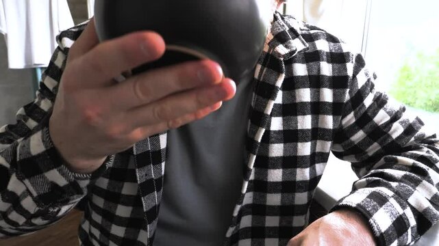 A man eats homemade food from a plate. Drink soup from a plate. Slow motion.