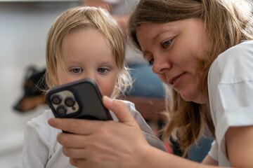 Mother and Child Bonding Time Viewing Content on Mobile