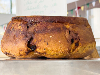 Traditional italian panettone with raisins and currants in bakery display