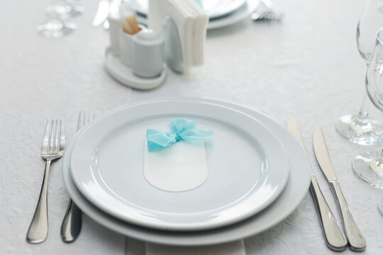 Elegant table setting with an empty menu card for a wedding or special event.