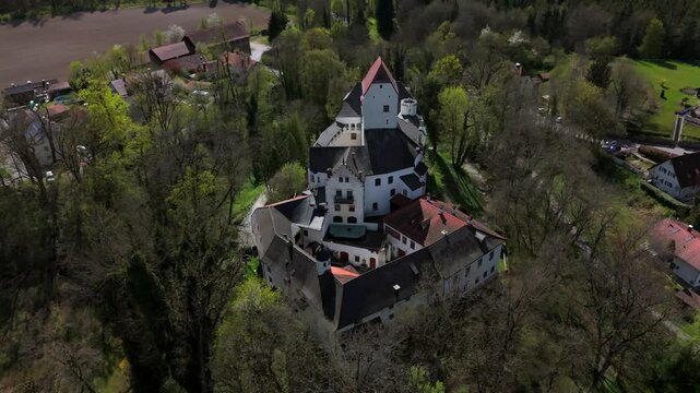 Aerial view of Schloss Elkofen, also known as Burg Elkofen, Schloss Elkhofen, near Grafing bei Muenchen, Germany. A medieval fortress surrounded by green fields in the Bavarian countryside. 