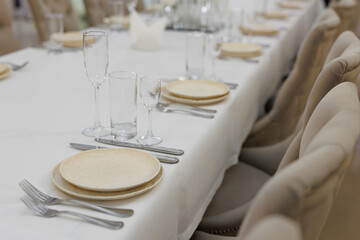Festive table setting. Glasses, plates, cutlery, napkins.