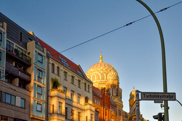 View to the dome and the small towers of New Synagogue in the downtown of Berlin in the evening sun.