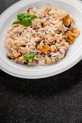Seafood rice risotto frut de mer mussels, shrimp, prawn, rapan, squid vegetable dish fresh delicious gourmet food background on the table rustic food top view copy space