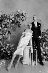 Young beautiful happy couple hugging and smiling near the arch