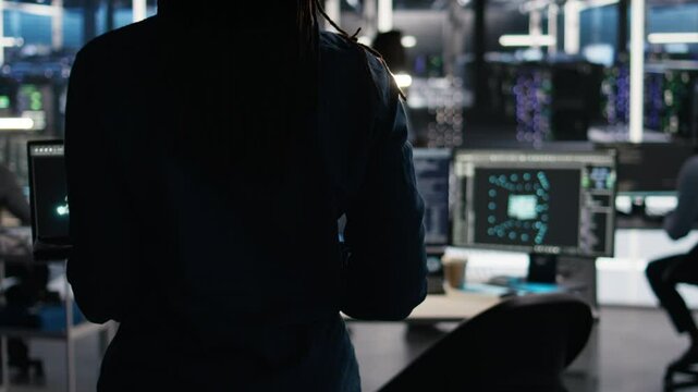 Server hub technician arriving in office, using AI visualization insights on PC to optimize system health. Data center IT specialist using computer node tree software to analyze gear issues, camera A