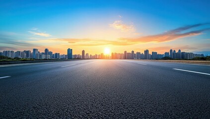 Fototapeta premium Empty asphalt road stretching to a city skyline at sunrise. Vast highway, modern cityscape, vibrant colors