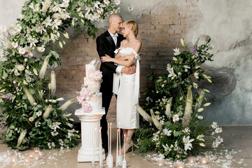 Young couple boy and girl cutting their wedding cake