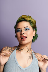 Stylish woman with colorful hair and striking makeup confidently poses against a pastel backdrop.