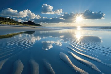 Sun rays create glistening reflections on beach water