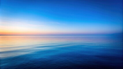 Obraz premium Serene Ocean Waters at Dawn A Tranquil Seascape Showing Calm Blue Water and a Pastel Sky