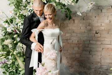 Young couple in love cutting their beautiful wedding cake