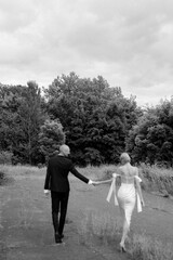 Young attractive couple walking holding hands
