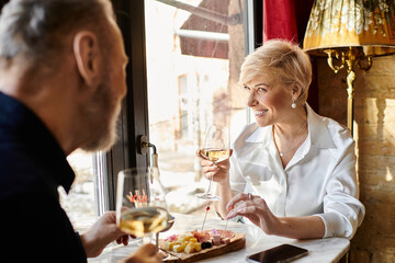 Romantic dining experience for a mature couple enjoying wine and conversation together