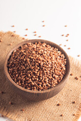 Buckwheat groats on wooden background. Healthy cereal concept.  