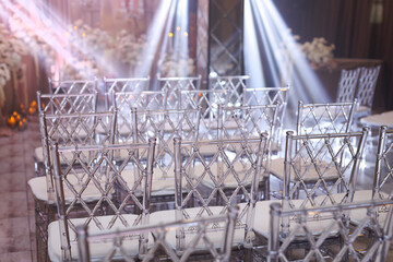White chairs for the wedding ceremony and wedding decoration.