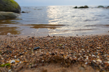 Close-Up View of a Tranquil Beach Scene with Gentle Waves and Rocks