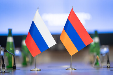 Flags of cooperation between Russia and Armenia. Flags of Russia and Armenia on the negotiating...
