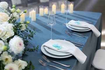 Elegant table setting with an empty menu card for a wedding or special event.