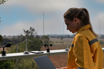 Person sitting  in the countryside. person with wind turbine in the field. engineer with turbine in...