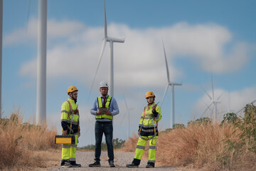 Service team wind turbine in the field. engineer group with turbine in the wind. engineer with...