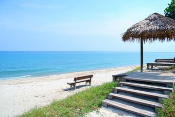 Tranquil beach scene with wooden bench and thatched roof shelter