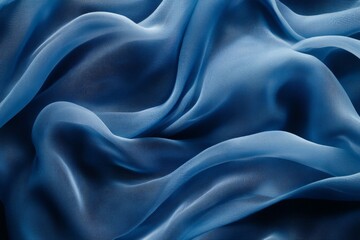 Obraz premium Soft blue fabric draped elegantly on a surface showcasing its delicate folds and texture