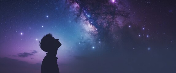 Obraz premium A silhouette of a head looking up at a starry cosmos background.