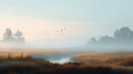 Obraz premium A foggy morning in a field with a river running through it