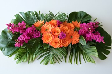 Colorful floral arrangement with orange roses and pink orchids on green leaves for decoration