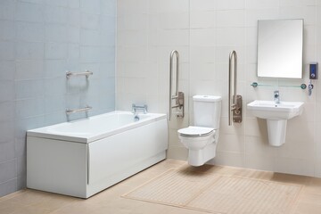 Side View Of Modern Bathroom With Bathtub, Toilet And Sink For People With Disabilities