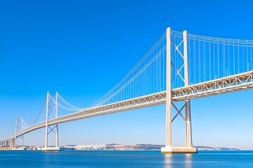 Modern suspension bridge spanning a calm blue waterway under a vibrant sky
