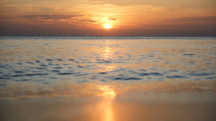 Landscape image of a beautiful sunset sky and sea wave on beach