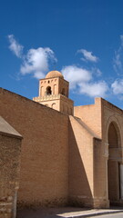 Fototapeta premium Stone dome on the top of a tower, rising above massive stone walls, in the Great Mosque of Kairouan in Kairouan, Tunisia