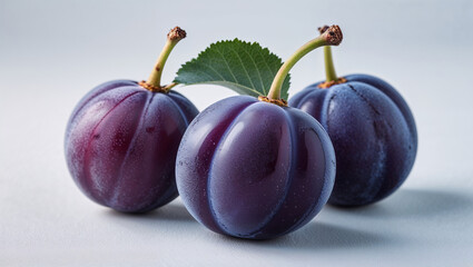 Three Fresh Plums With Leaf Isolated On White Background Close Up