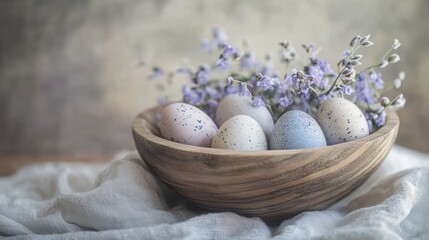 Obraz premium Wooden bowl filled with hand-dyed Easter eggs and dried flowers