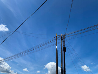 high voltage power lines against blue sky with bunch of wires. Aesthetic, technology, electrical,...
