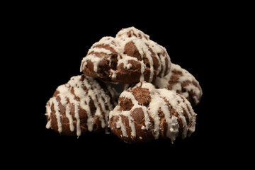 Profiteroles with coconut cream on a black background.